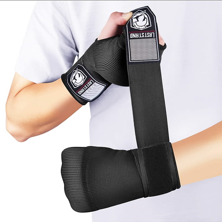 Black gel boxing hand wrap glove with textured fabric and white logo patches on the adjustable strap shown from the back side