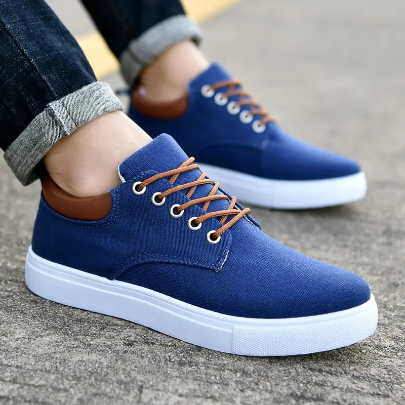 Men’s breathable casual sport blue canvas sneakers with brown laces and white rubber soles.
