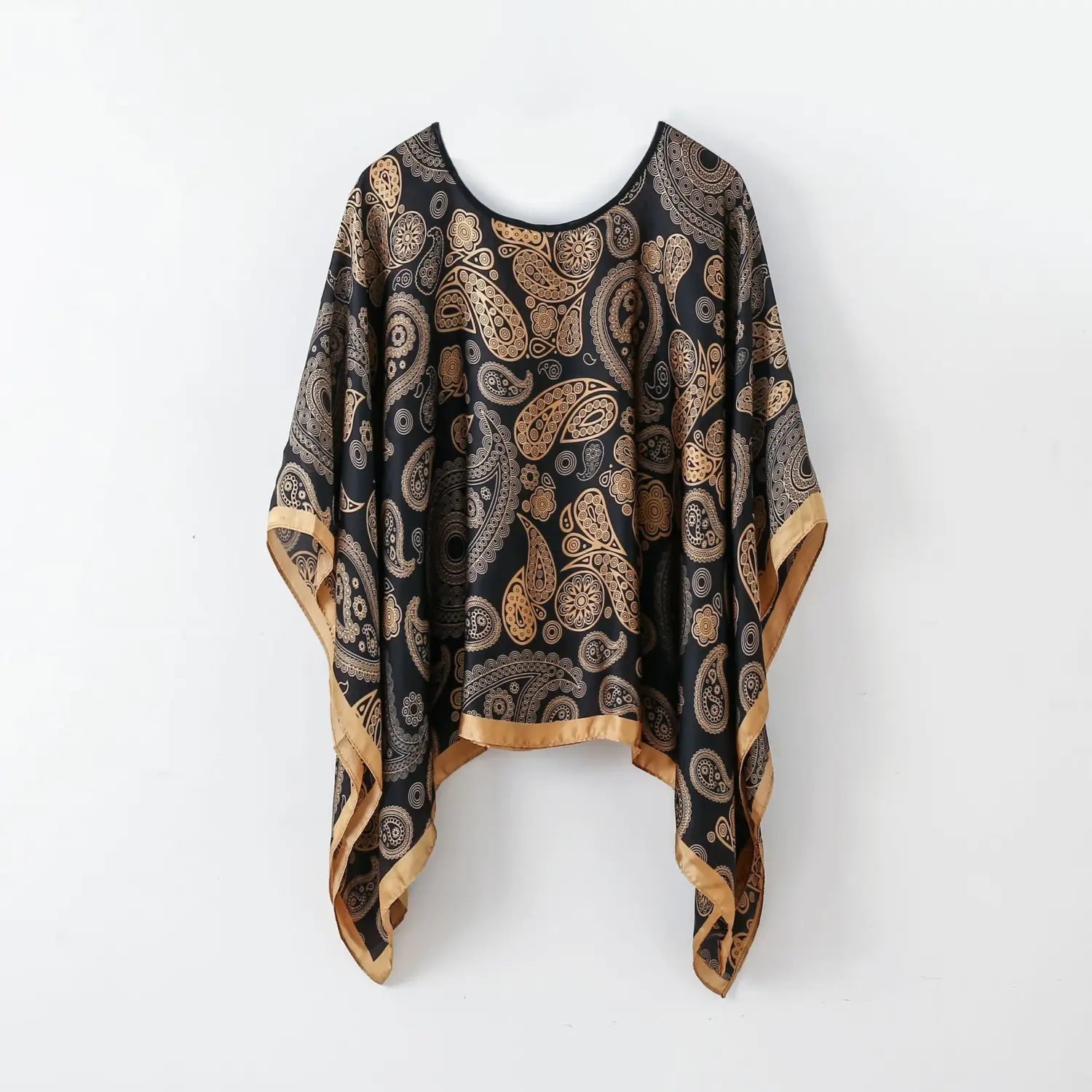 black and gold paisley patterned silk pullover shawl cape with satin trim for outerwear.