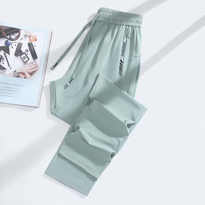 Light green anti mosquito casual athletic trousers with a drawstring waistband and side pockets featuring black fashion branding.