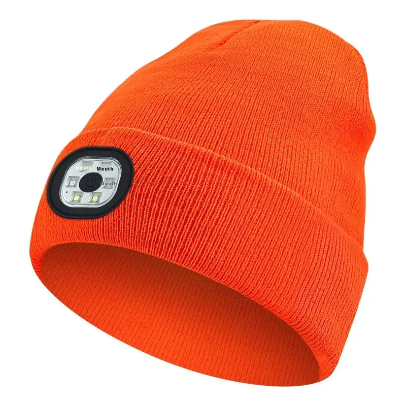 Bright orange knitted led bluetooth beanie hat with a black circular rechargeable washable led light panel on the side.