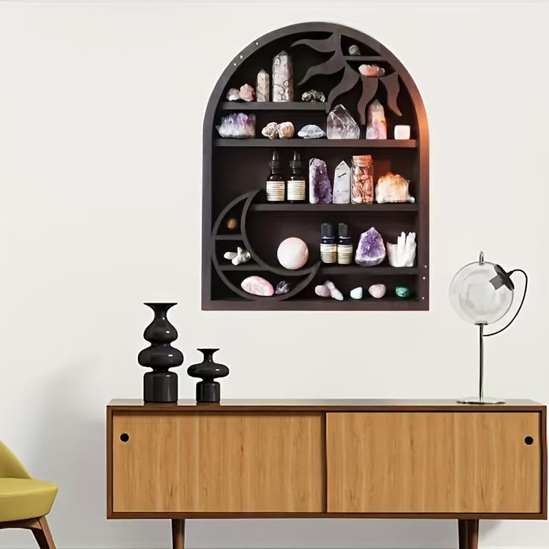 Dark wood arched shelf with moon and sun cutout design in black wood displaying crystals minerals and essential oil bottles as a floating crystal display rack.