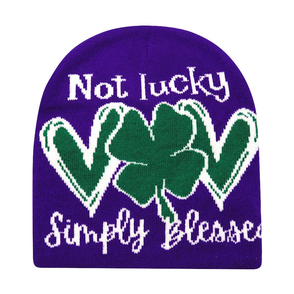Purple knit Lucky knitted beanie winter warm hat featuring a green shamrock with white trim and the phrases not lucky and simply blessed in white knitted lettering.