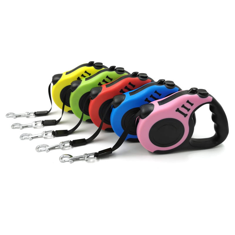 A set of colorful retractable dog leashes with ergonomic handles in yellow, green, red, blue, and pink featuring black accents and metallic silver clasps.