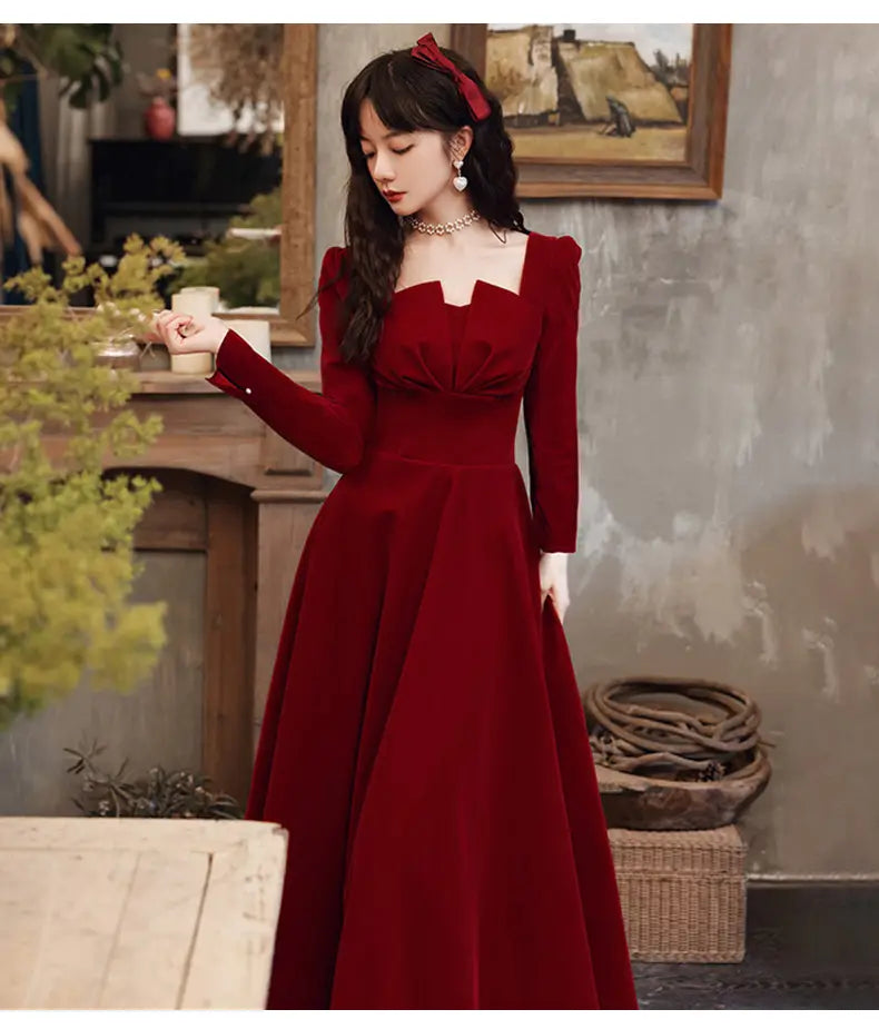 a rich burgundy velvet long sleeve a-line gown with a square neckline perfect for formal occasions