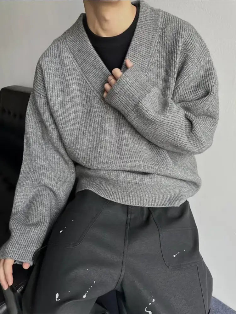 Gray ribbed knit v-neck sweater with a relaxed fit made from soft, comfortable material for casual wear.