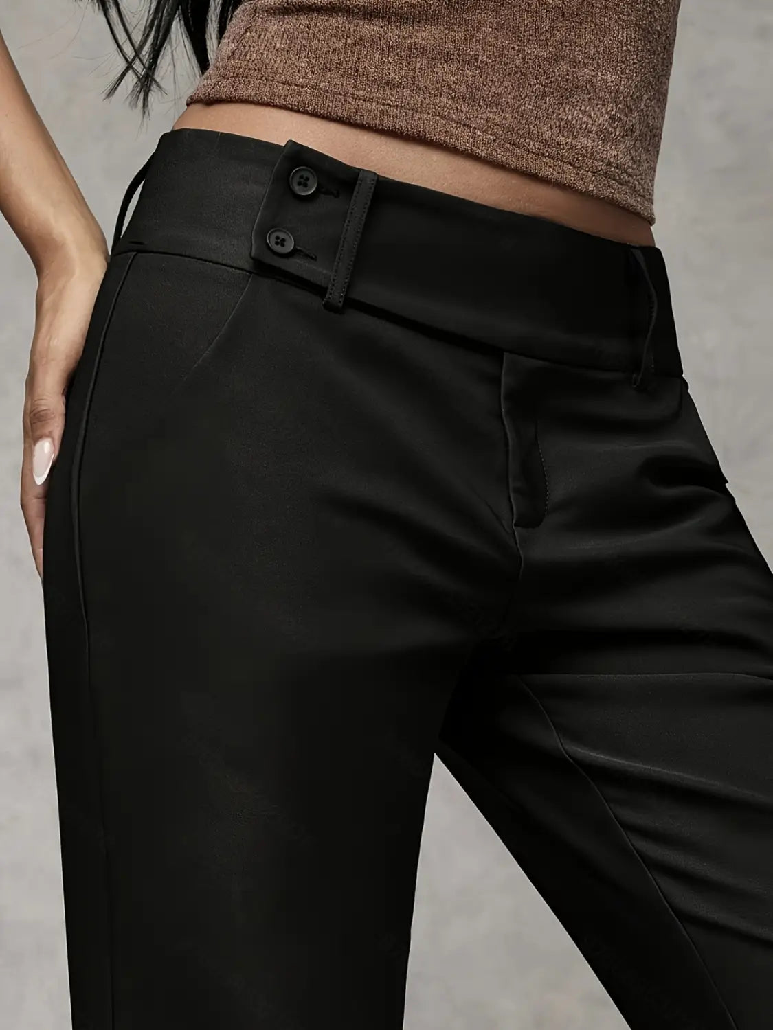Black high-waisted wide leg work pants with a sleek tailored fit and buttoned belt detail for casual wear.