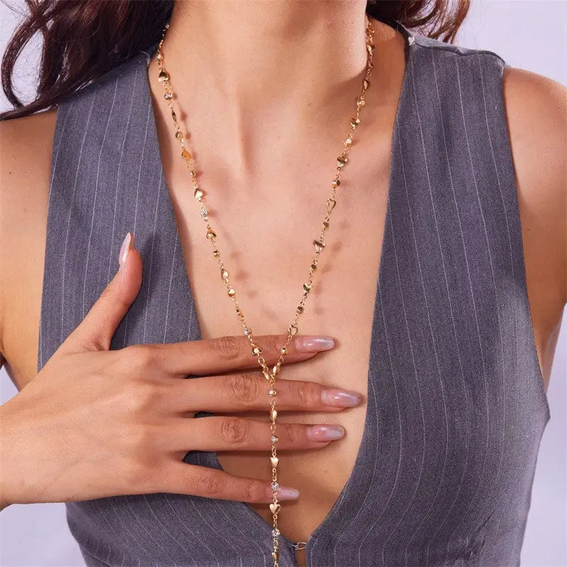 Gold-toned chain necklace featuring delicate irregularly shaped metallic beads and a multicolor crystal geometric gold pendant.