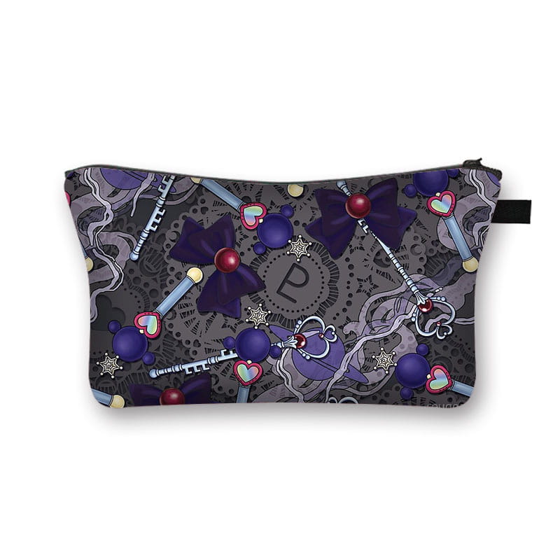 A dark gray cosmetic bag featuring a whimsical pattern of purple bows keys with red jewels and heart-shaped charms on a lace-like background for travel use.