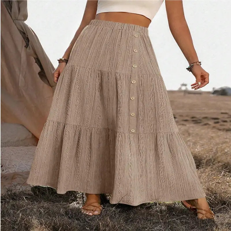 Beige tiered maxi skirt with textured lightweight fabric and button closure down the front for casual wear.