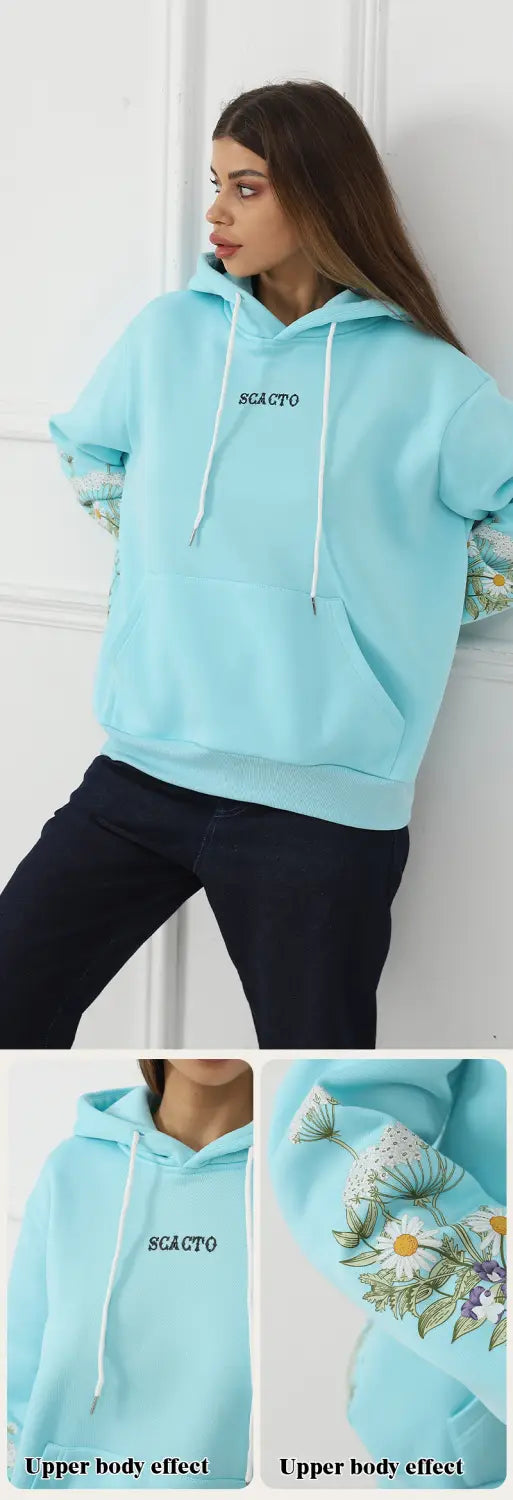 Light blue women’s long sleeve hoodie with embroidered floral pattern on the sleeves and scacto text printed across the chest.