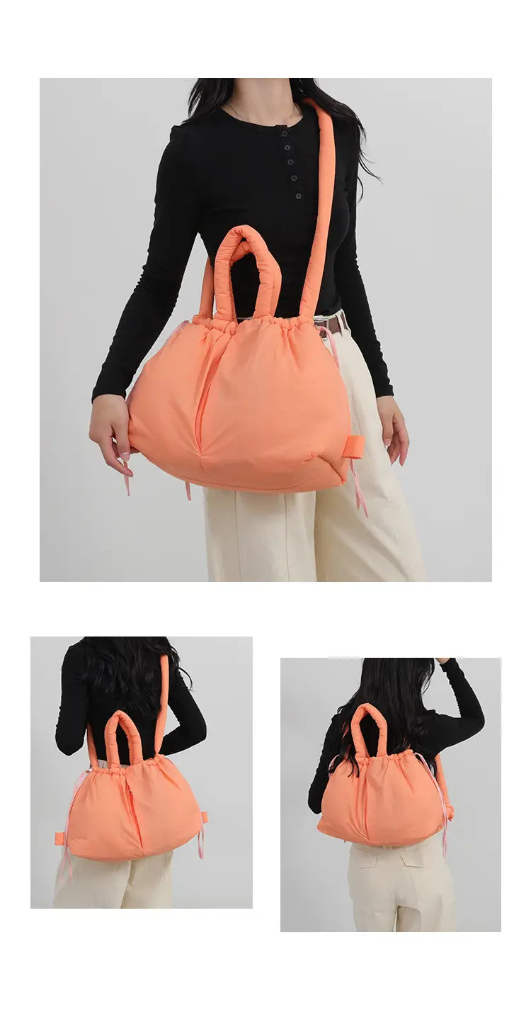 A soft peach-colored quilted puffer tote bag with a lightweight nylon drawstring and matching shoulder strap.