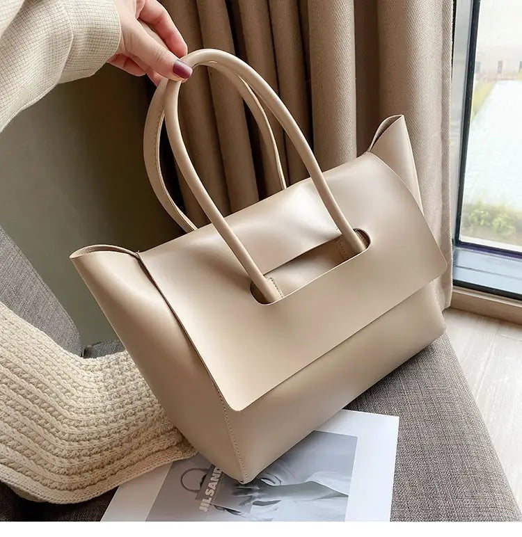 Beige leather vintage structured tote bag with dual top handles and a defined silhouette.