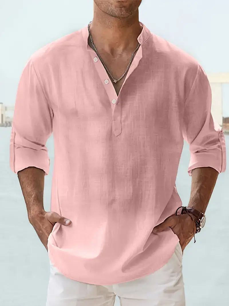 a soft pink mens lightweight mandarin collar shirt made of linen and cotton featuring long sleeves with rolled cuffs and a relaxed fit