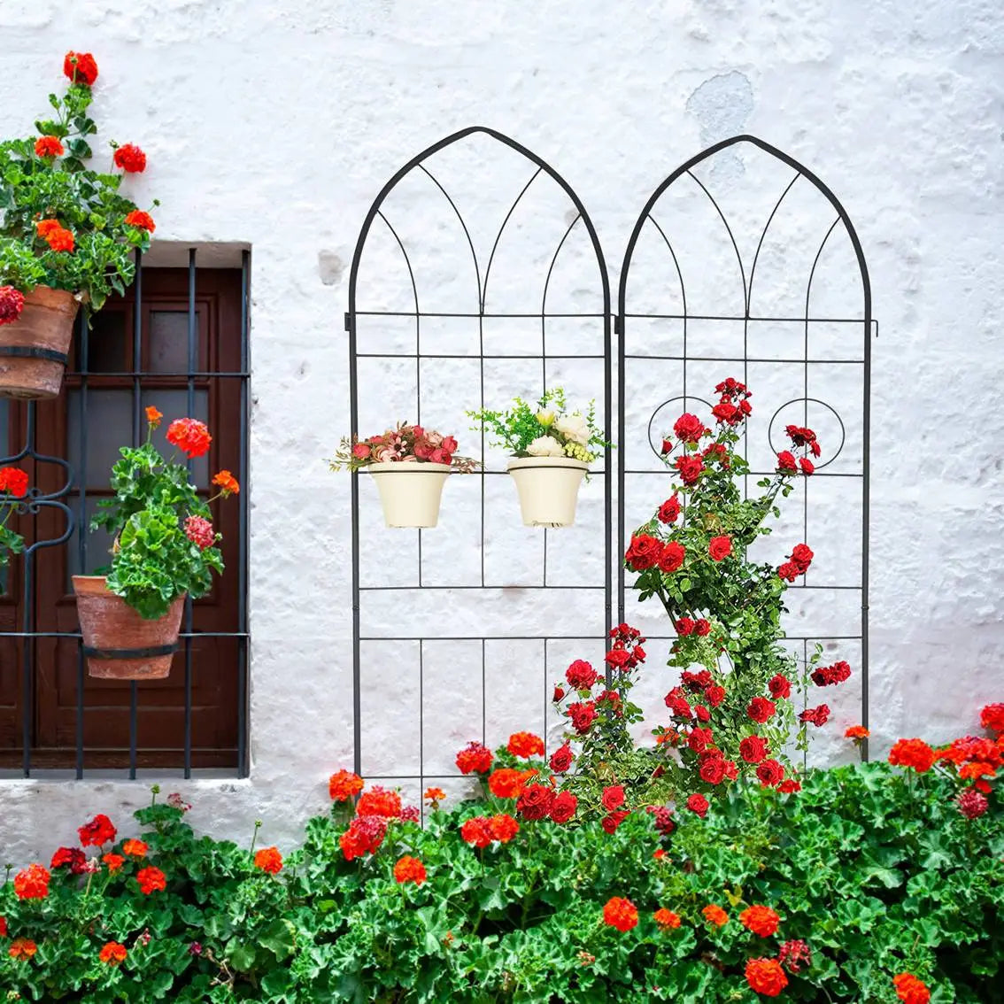 Black wrought iron metal garden trellis 4 pack with arched top and circular accents designed for climbing plants.