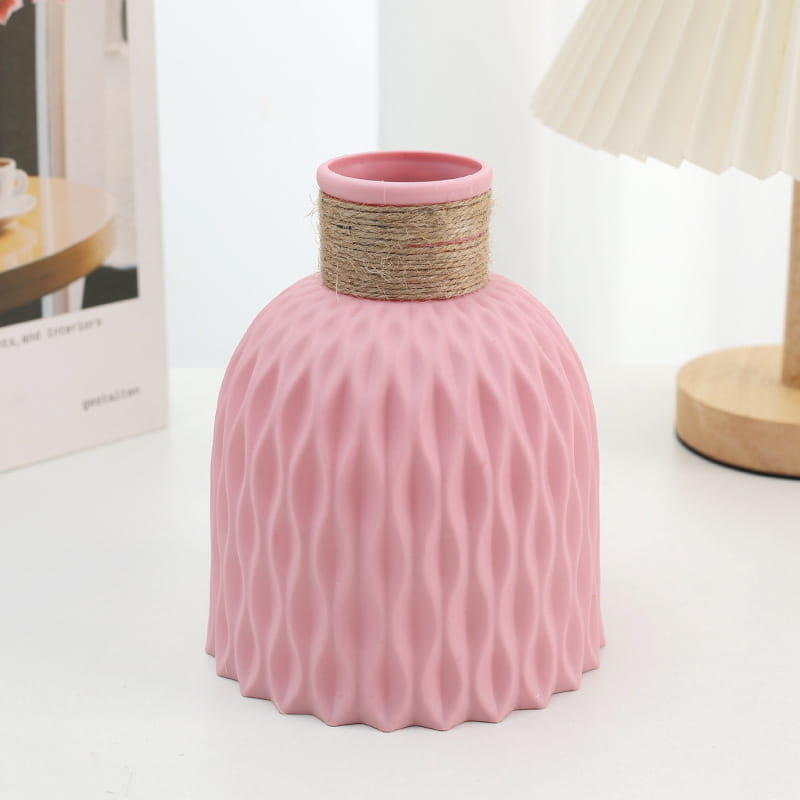 Pink ceramic vase with textured wavy pattern and natural twine band around the neck from ceramic vase set with twine and wavy texture 4 pack.
