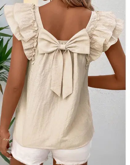 beige textured square neck butterfly sleeve blouse showing the back side with a ruffled top and bow detail.