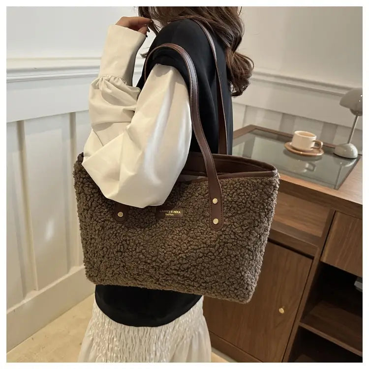 Brown faux fur tote bag with leather handles and gold tone hardware displayed from the front.
