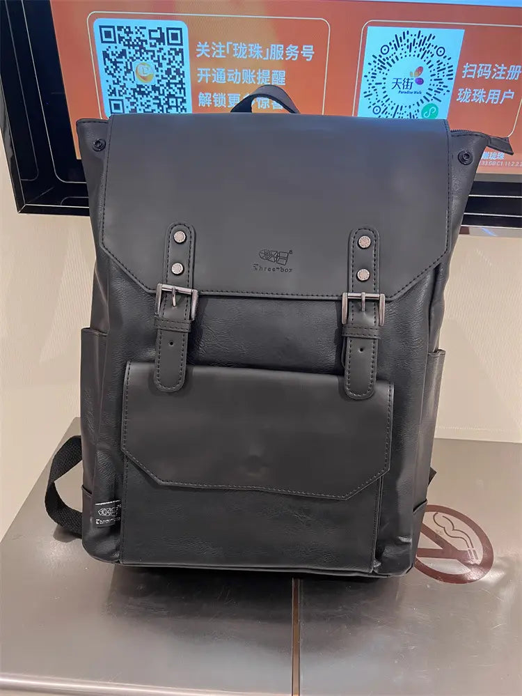 Black leather vintage college backpack with silver-toned buckle straps and front flap closure large capacity travel bag.