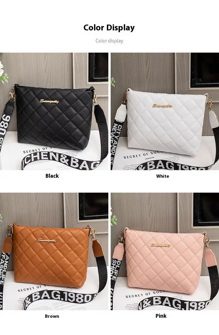 Quilted chain messenger bag in black with a gold-tone logo and contrasting striped crossbody strap made of leather.