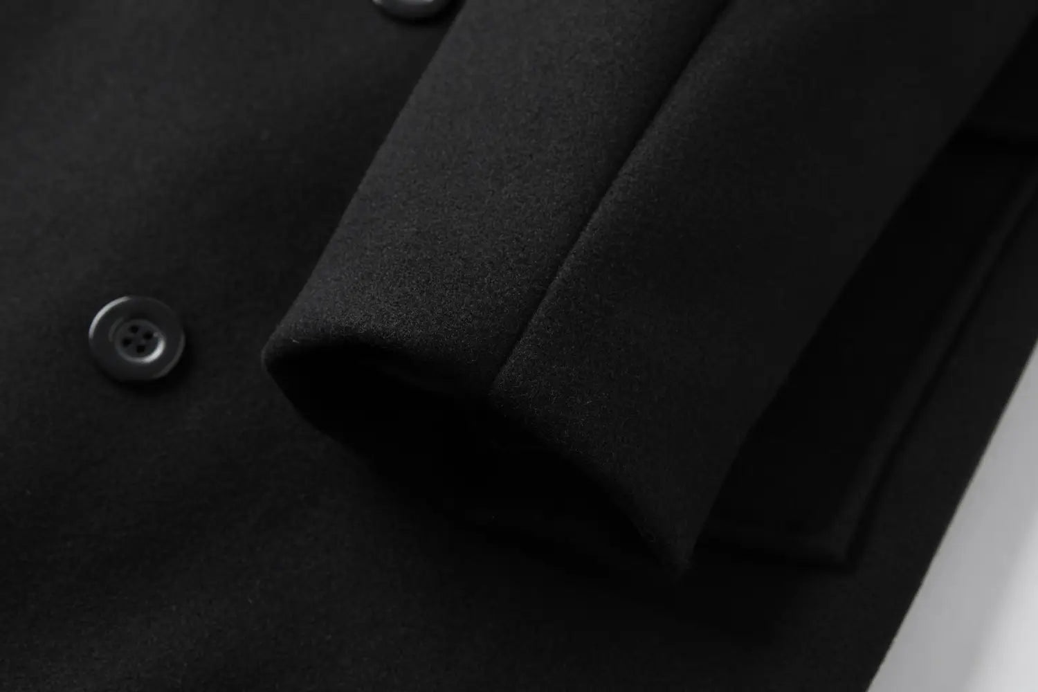 Men double breasted wool overcoat mid length coat in black wool with dark gray buttons and a structured tailored design.