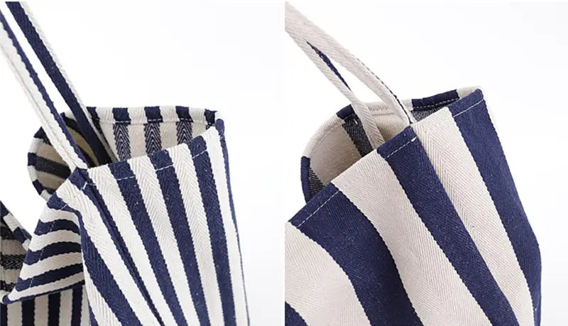 Navy and white striped canvas tote bag with sturdy handles for high capacity shoulder use.