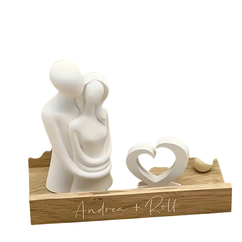 White ceramic couple figurine with smooth rounded forms on natural wood plaque engraved ich du wir in 3d couple hug silicone candle mold