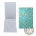 Clear plastic 3d floral embossing folder with easter bunny and egg designs for card making on light blue background