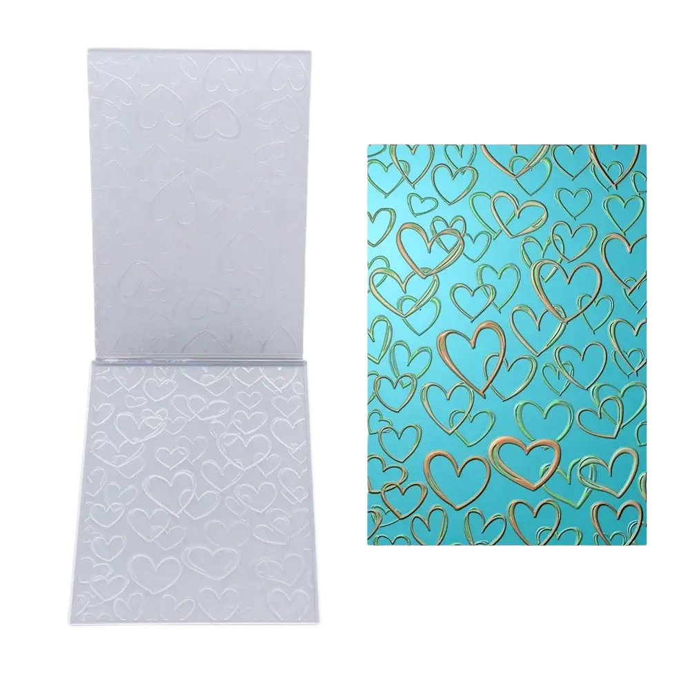 Clear plastic 3d floral embossing folder with embossed heart pattern shown beside gold heart design on teal background