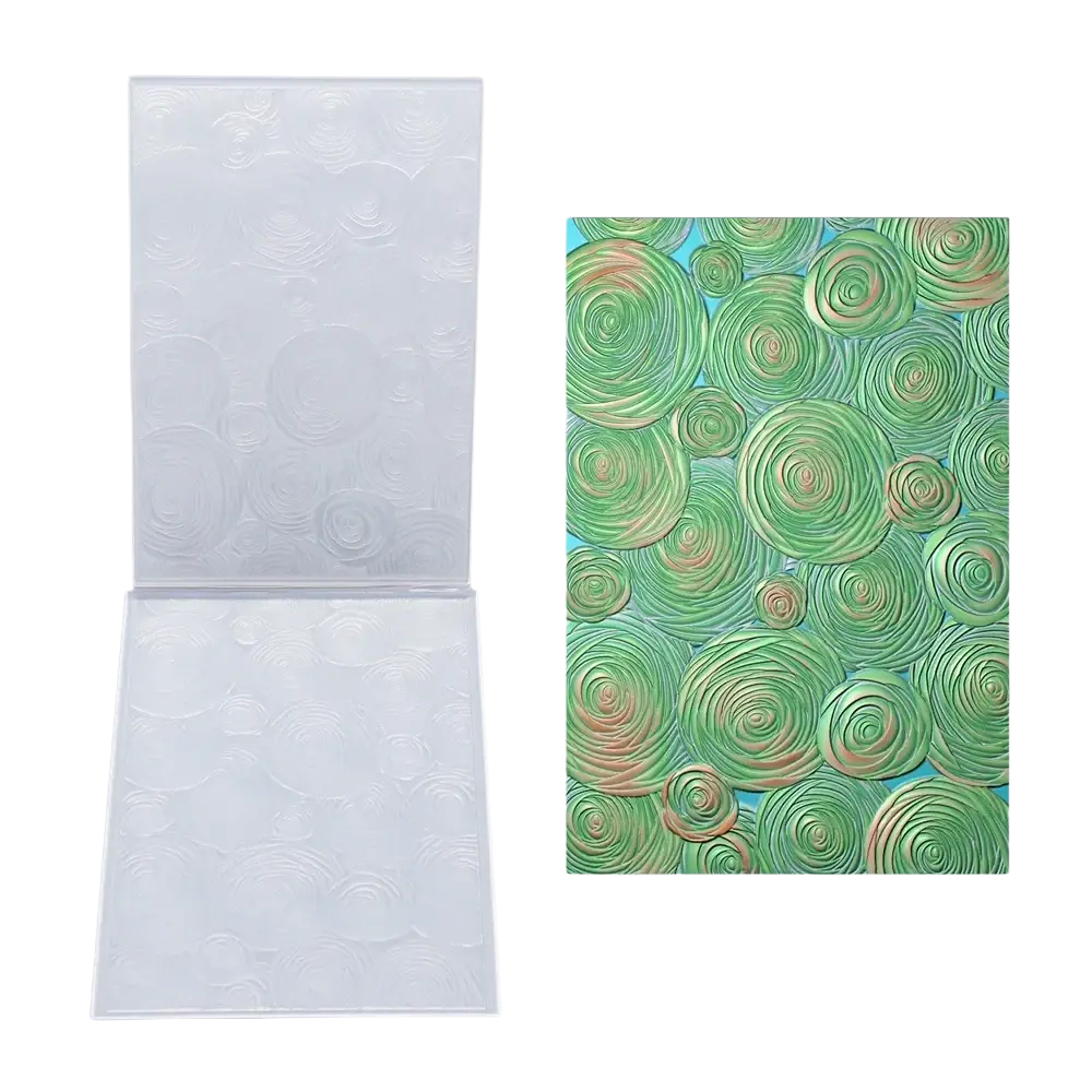 Clear plastic 3d floral embossing folder with circular patterns shown beside green and gold spiral design for card making