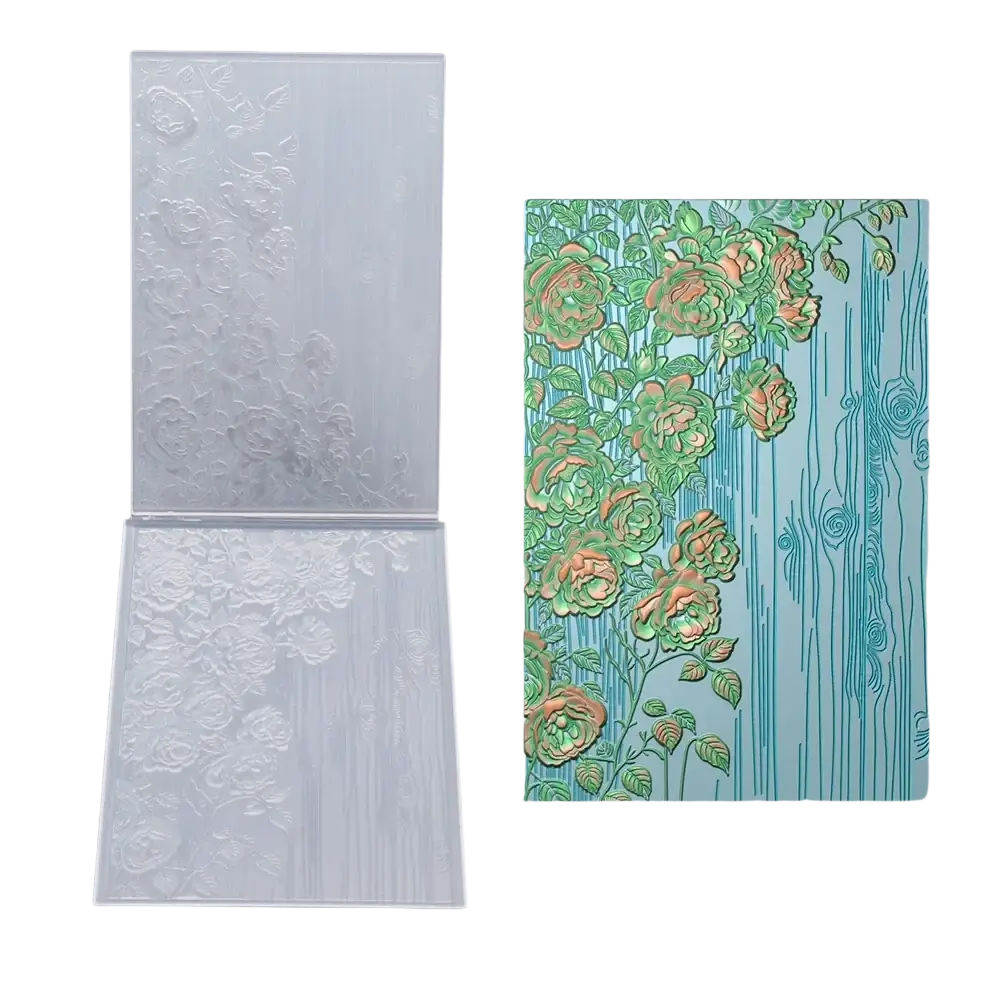 Clear plastic 3d floral embossing folder with raised design and colorful green and peach rose stamped on teal wood background
