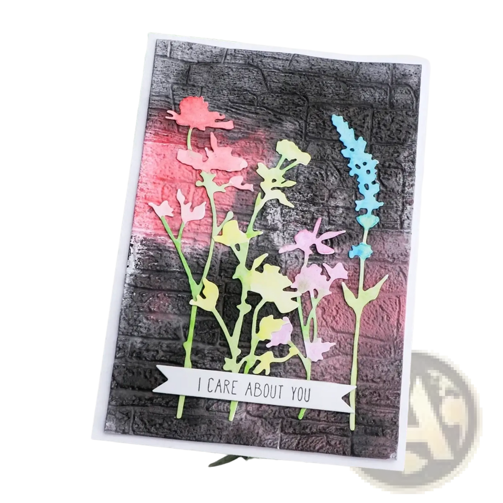 A handmade greeting card with 3d floral embossing folder featuring pink yellow and blue layered paper flowers and care banner