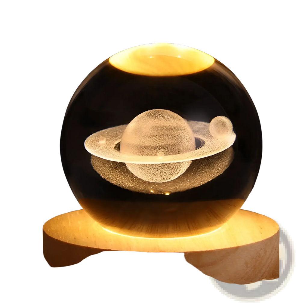 A warm-glowing transparent 3d galaxy crystal ball led night light featuring an engraved saturn with rings and a moon