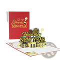 A festive red and gold 3d pop up happy new year card with intricate paper cutouts of champagne bottles fireworks and gifts