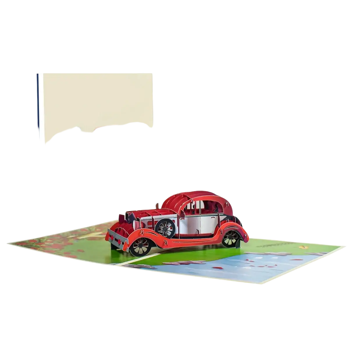 A red and white vintage car 3d pop up valentine card with detailed black wheels and chrome accents on a landscape background
