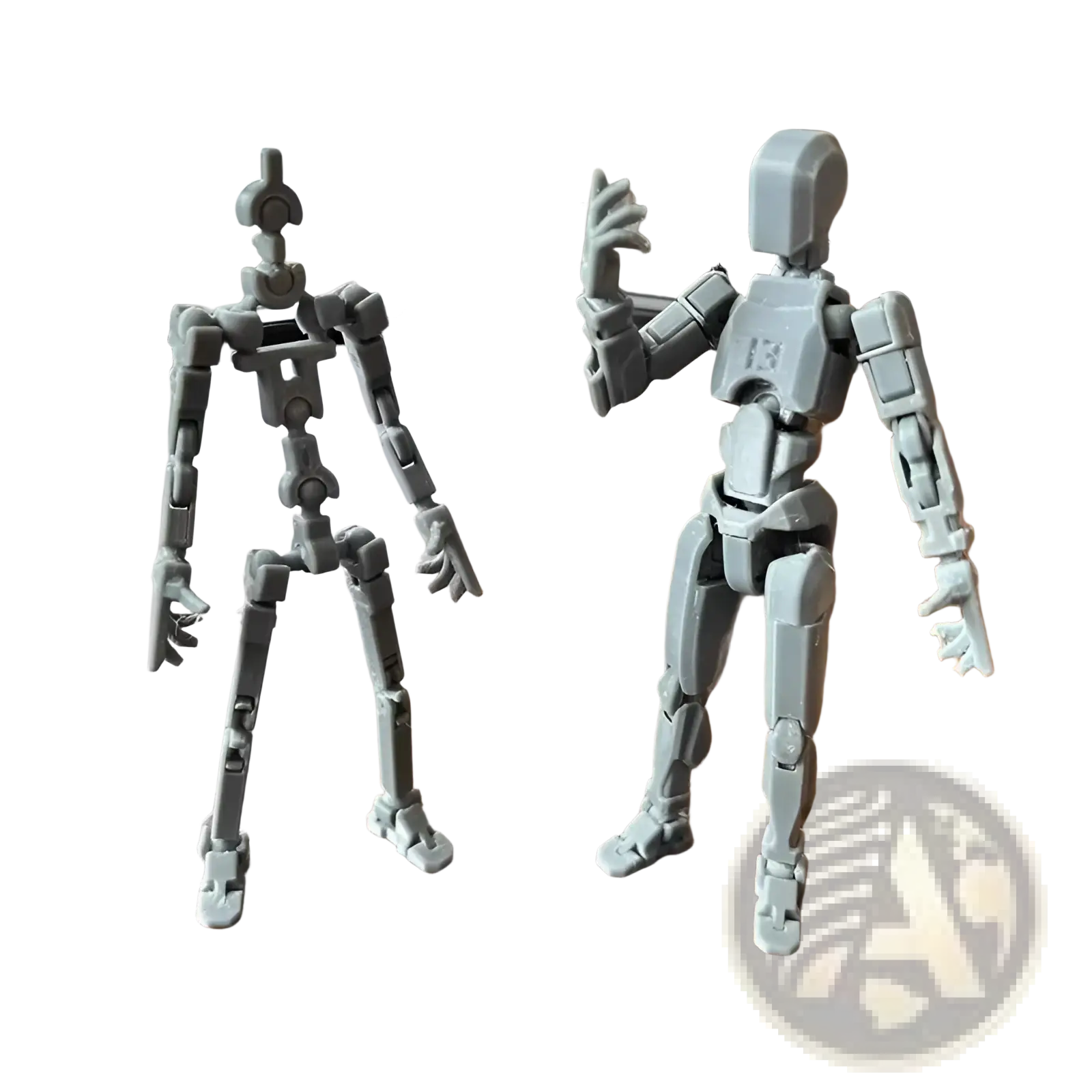 Two gray 3d printed articulated robot action figure dummies with jointed limbs and blocky designs side by side