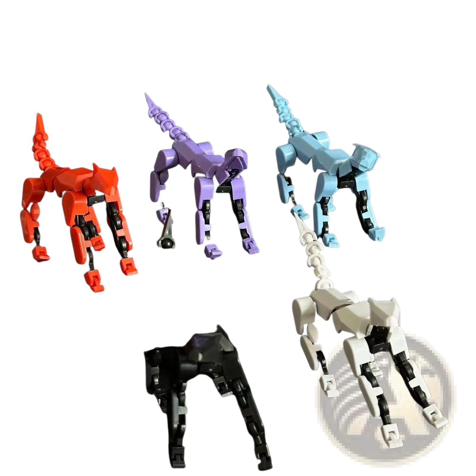 Three 3d printed multi jointed action figure dummy toys in red purple blue and white on a black surface