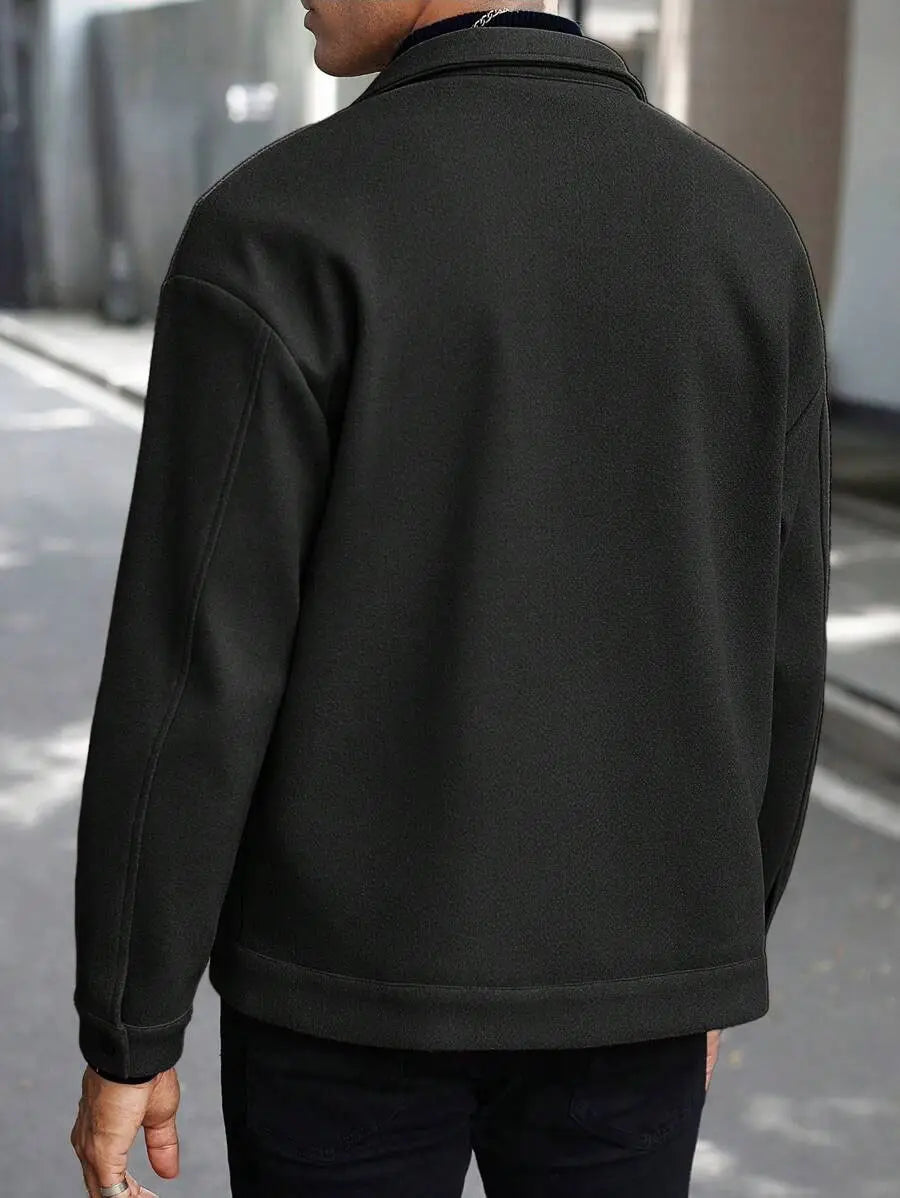 Men’s classic slim fit wool blend lapel jacket in black with textured fabric ribbed cuffs and hem viewed from the front.