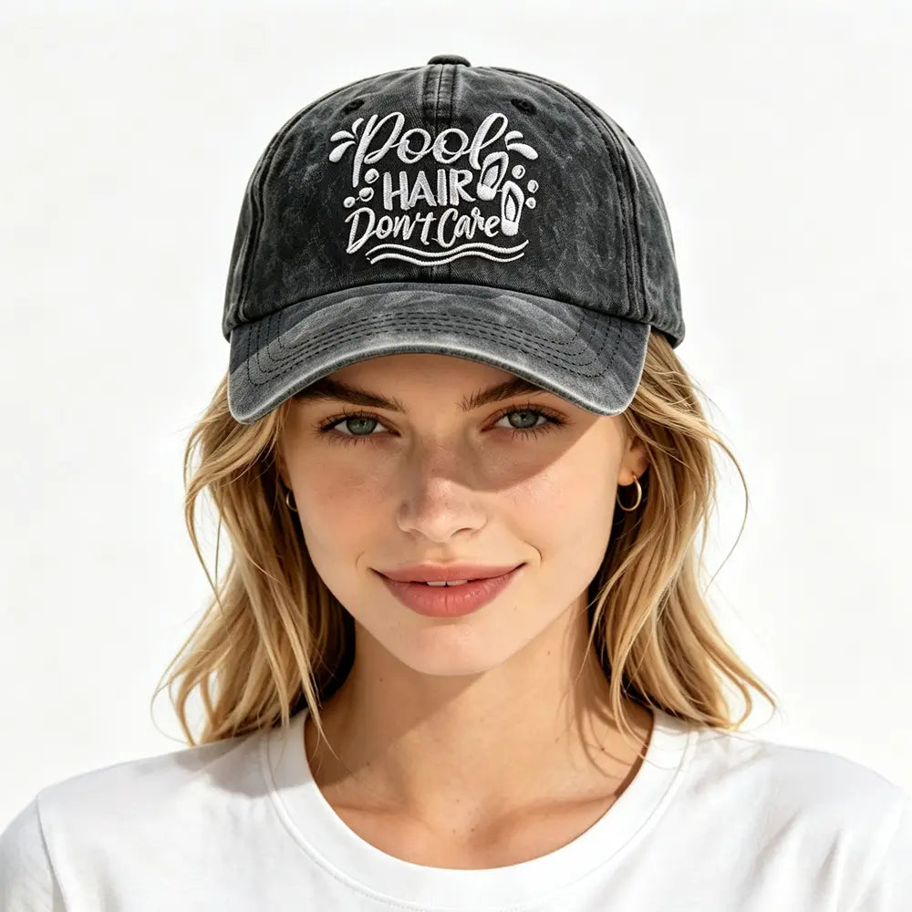 Black distressed baseball cap with white embroidered text reading pool hair don’t care and decorative wave and flip-flop motifs in a pool hair don’t care vintage baseball cap design.