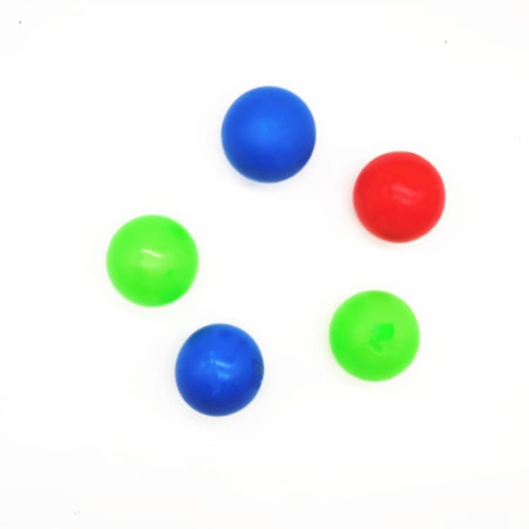 Five colorful plastic sticky wall ball stress relief glow squash toys in blue red and neon green.