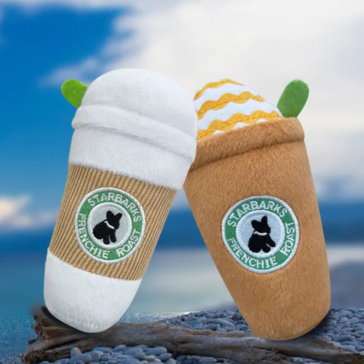 two plush dog toys designed as starbucks coffee cups featuring one with white foam and another with yellow wavy-striped foam in a dog plush coffee cup squeaky toy 2 pack