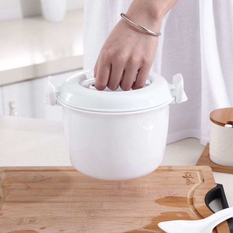 White ceramic microwave rice cooker with matching steamer lid and two side handles for easy cooking and handling.