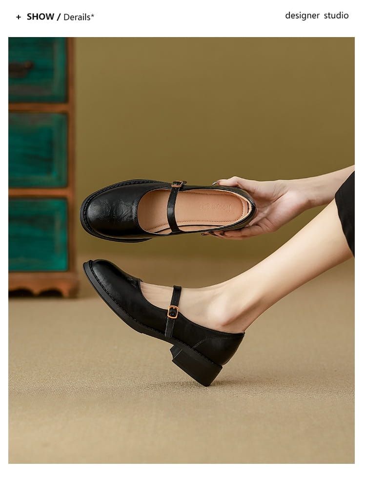 Black leather mary jane shoes with a low block heel and a single strap across the foot.