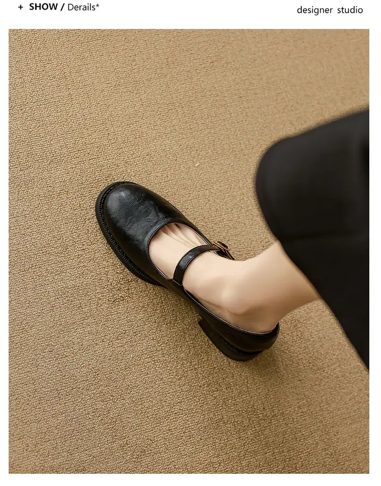 Black leather mary jane shoes with a strap across the foot and a low block heel.