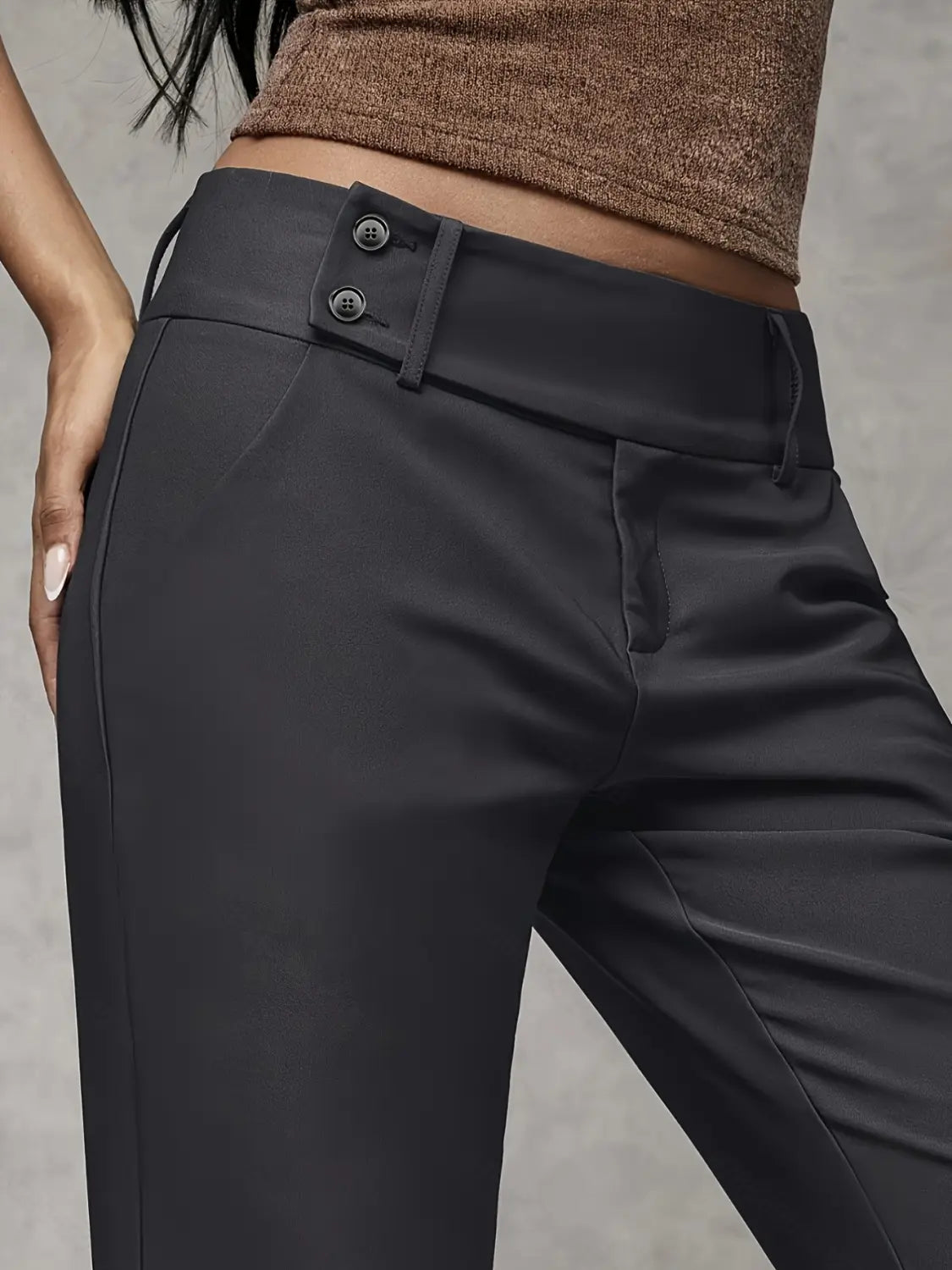 Black high-waisted wide leg work pants with a sleek tailored fit and double-button closure at the waistband designed for casual wear.