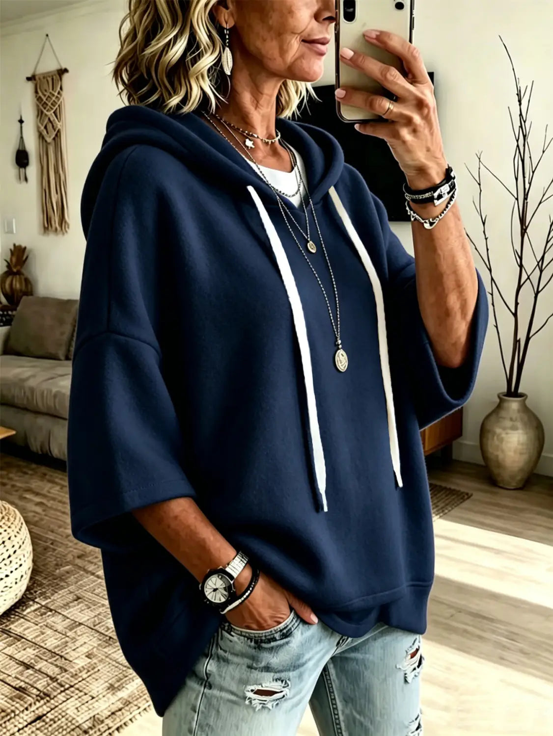 Navy blue oversized fleece hooded top with three-quarter sleeves and white drawstrings.