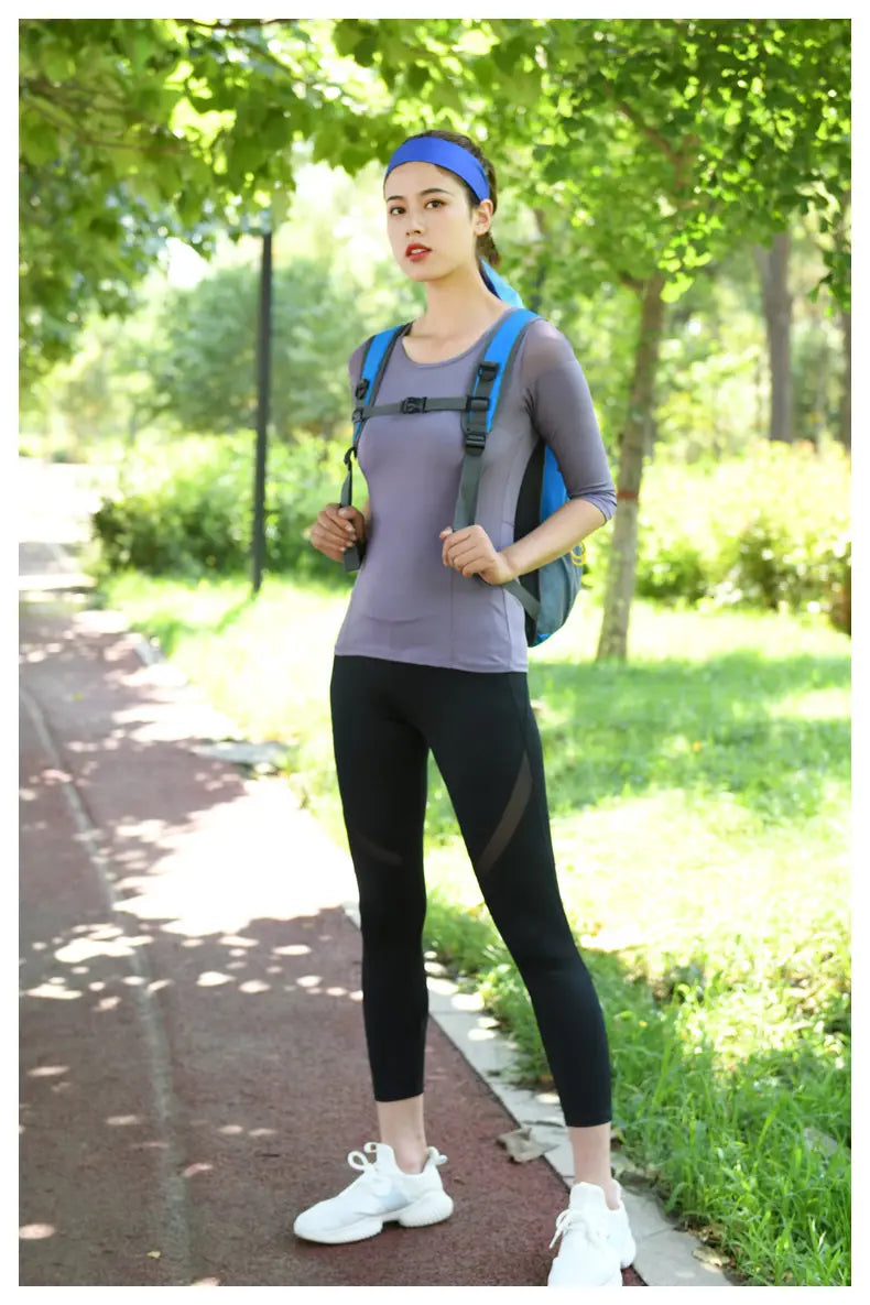 Blue and gray lightweight hydration backpack with adjustable straps designed for outdoor cycling use shown from the back side