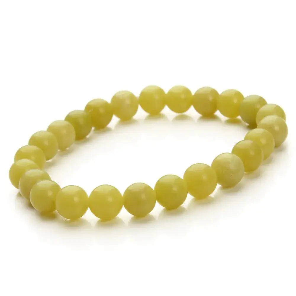 A delicate yellow-green natural polished gemstone and agate beaded bracelet composed of smooth round stones with a subtle faceted texture.