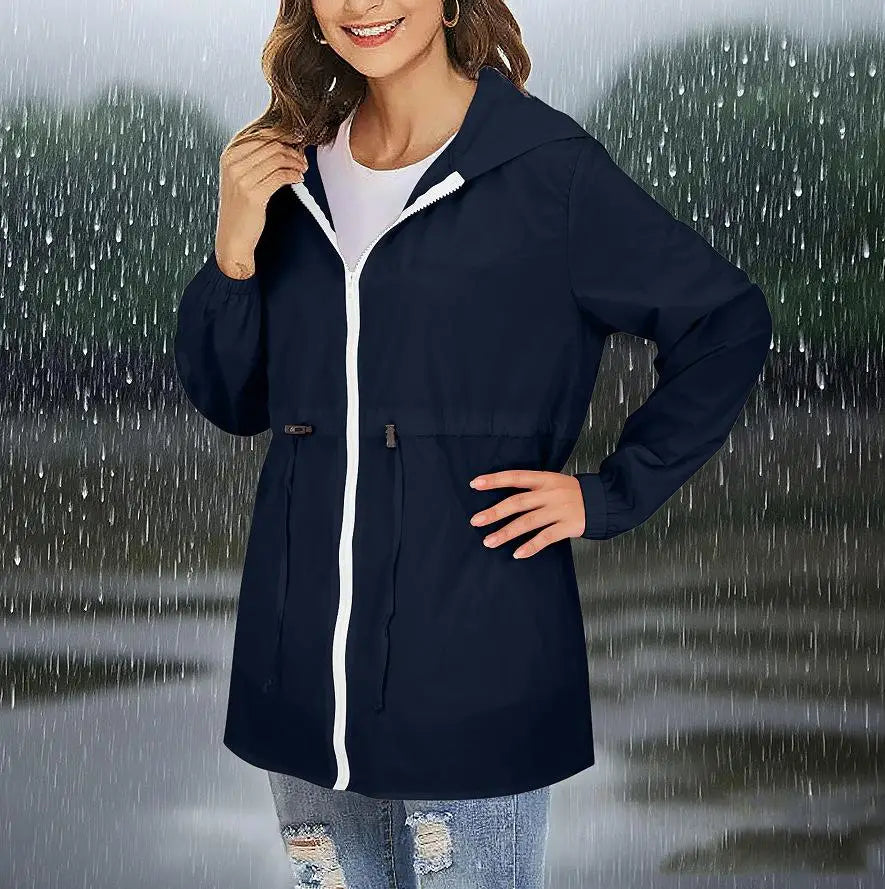Marineblaue, wasserdichte Windbreaker-Regenjacke mit Kapuze für Damen mit weißem Reißverschluss und Verzierung, ausgelegt für den Außenschutz.