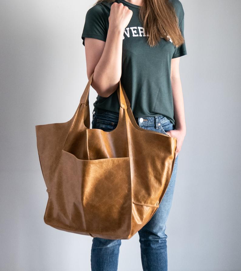 Brown leather tote bag with two handles and a front pocket large capacity soft slouchy shoulder bag.
